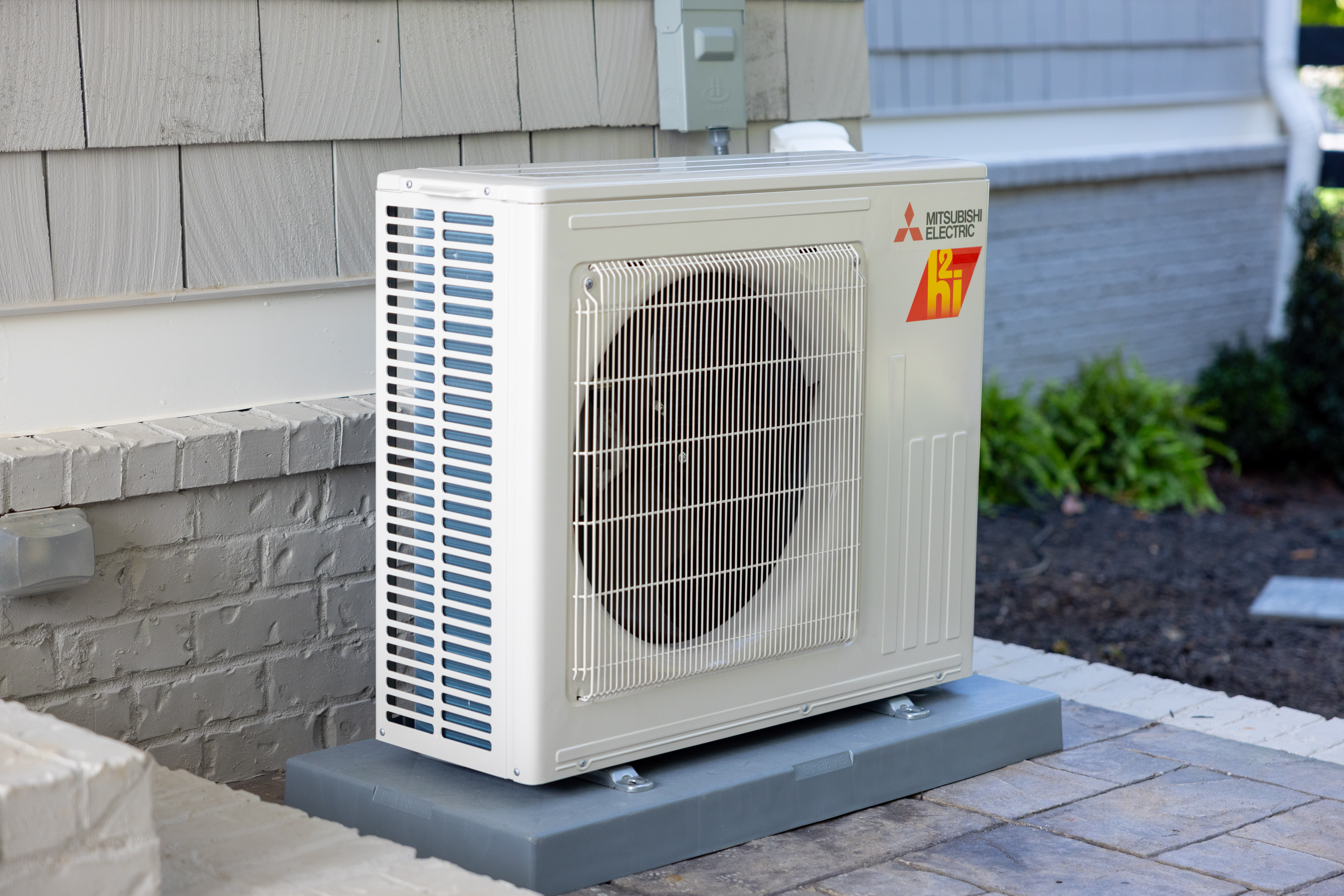 Mitsubishi Electric single-zone outdoor unit installed beside a home