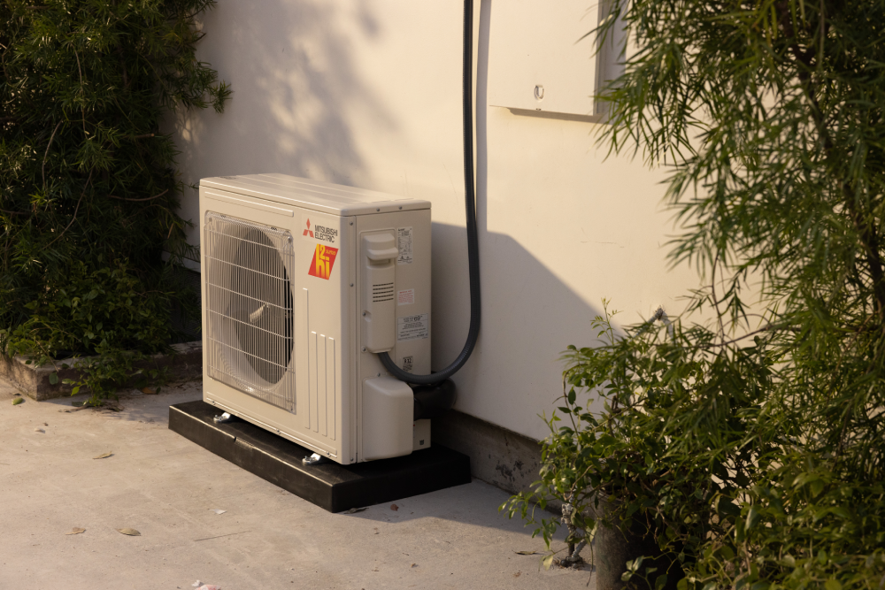 Mitsubishi Electric outdoor condenser tucked beside a patio
